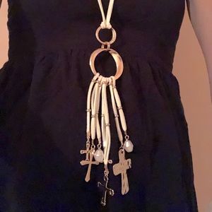 Beautiful gold long cross necklace with a leather white adjustable rope